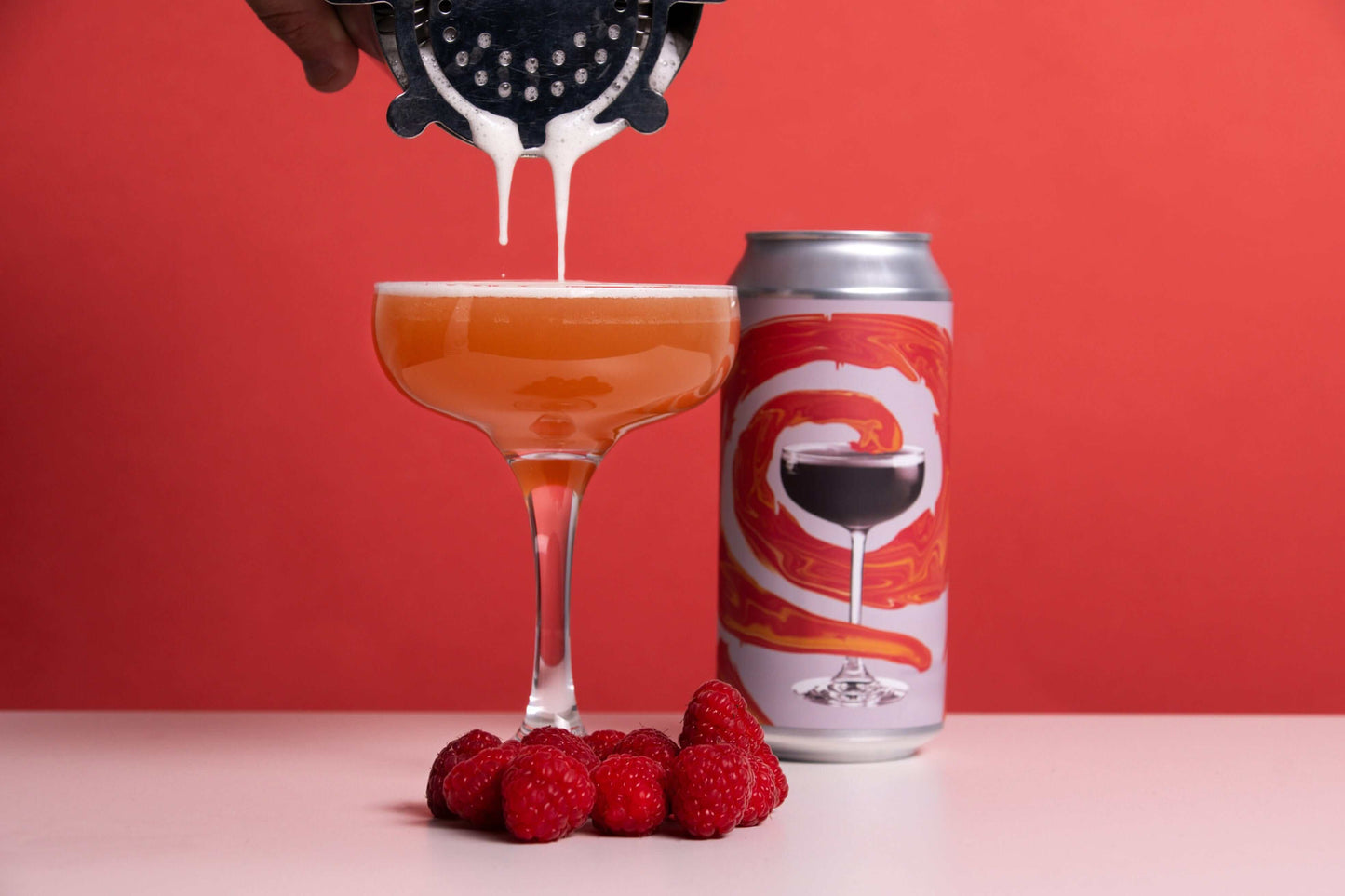 French Martini Pale Ale with raspberry garnish and creamy pour, highlighting flavors of pineapple, raspberry, and vanilla.